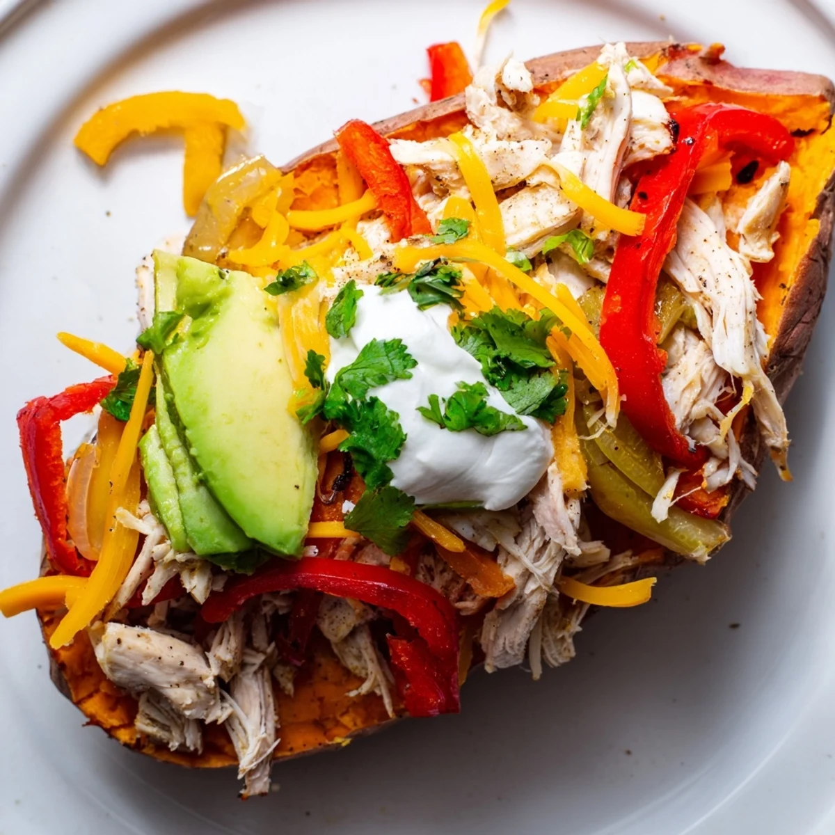 Golden-brown roasted Chicken Fajita Stuffed Sweet Potatoes brimming with spicy chicken, peppers, onions, and melty cheese.