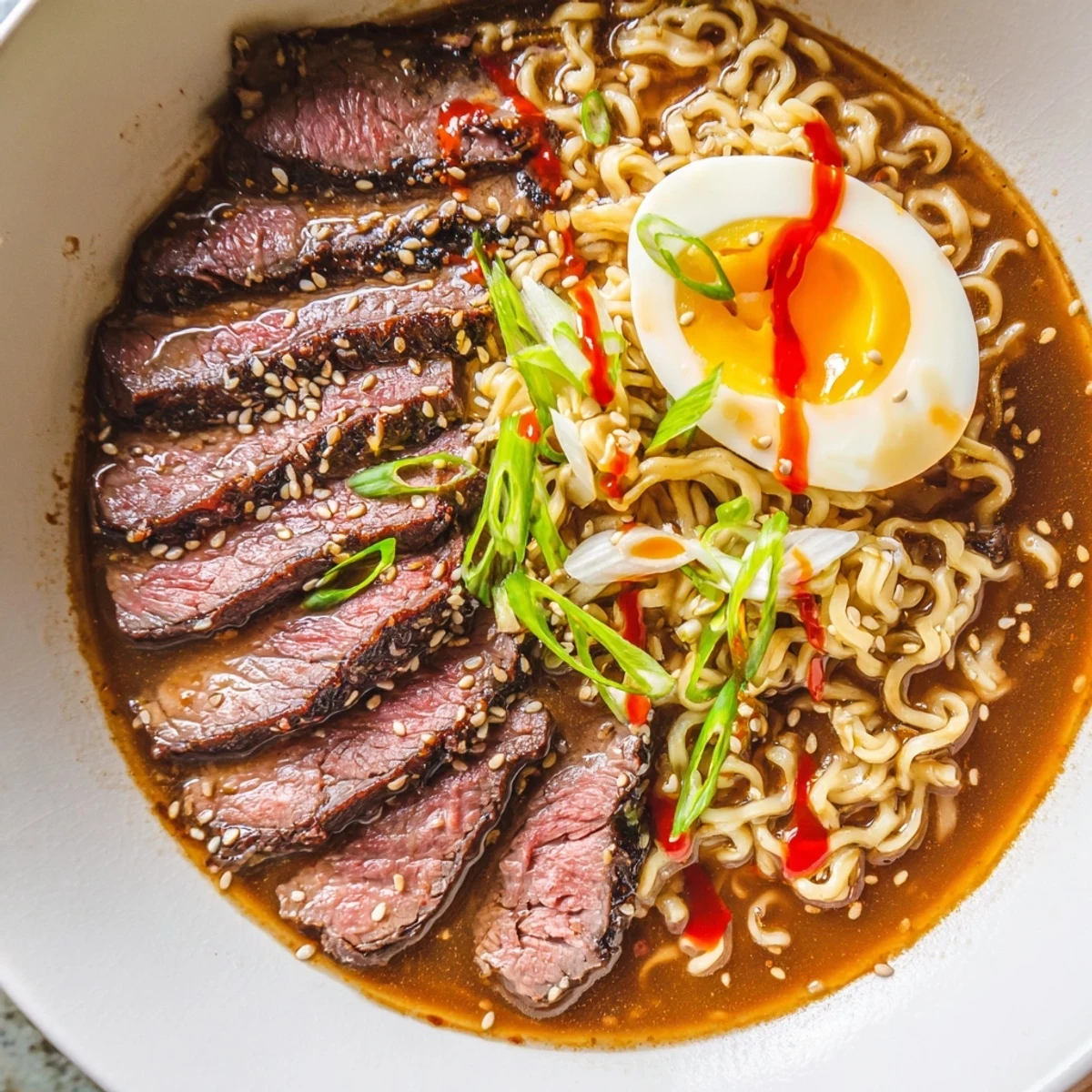 Fragrant, spicy umami broth poured over ramen noodles topped with jammy soft-boiled eggs and fresh scallions.